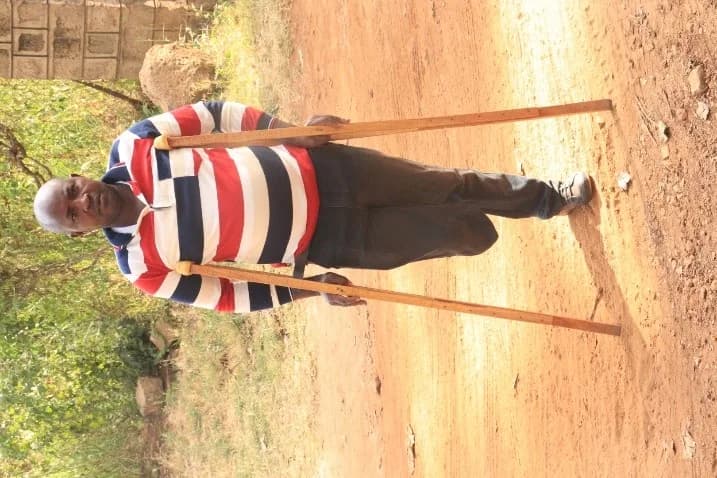 Mwenda walking with crutches