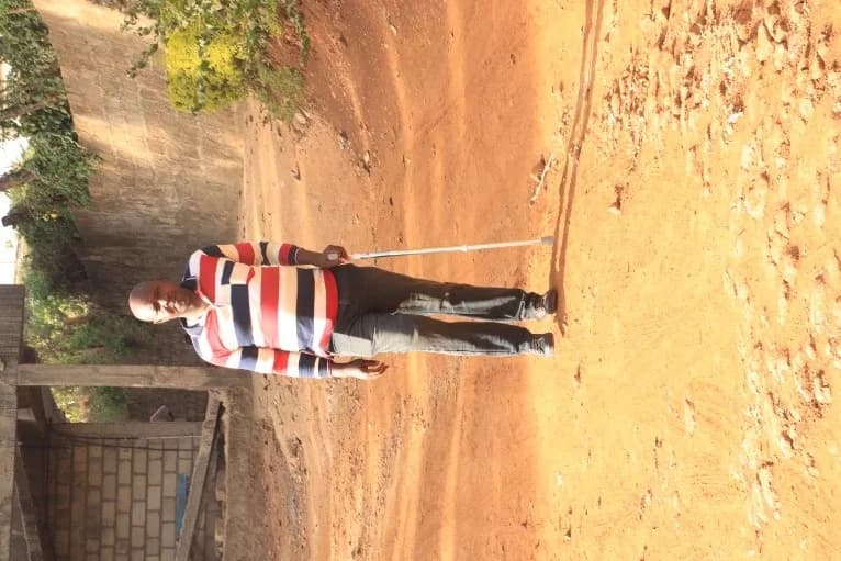 Mwenda walking with his prosthetic limb